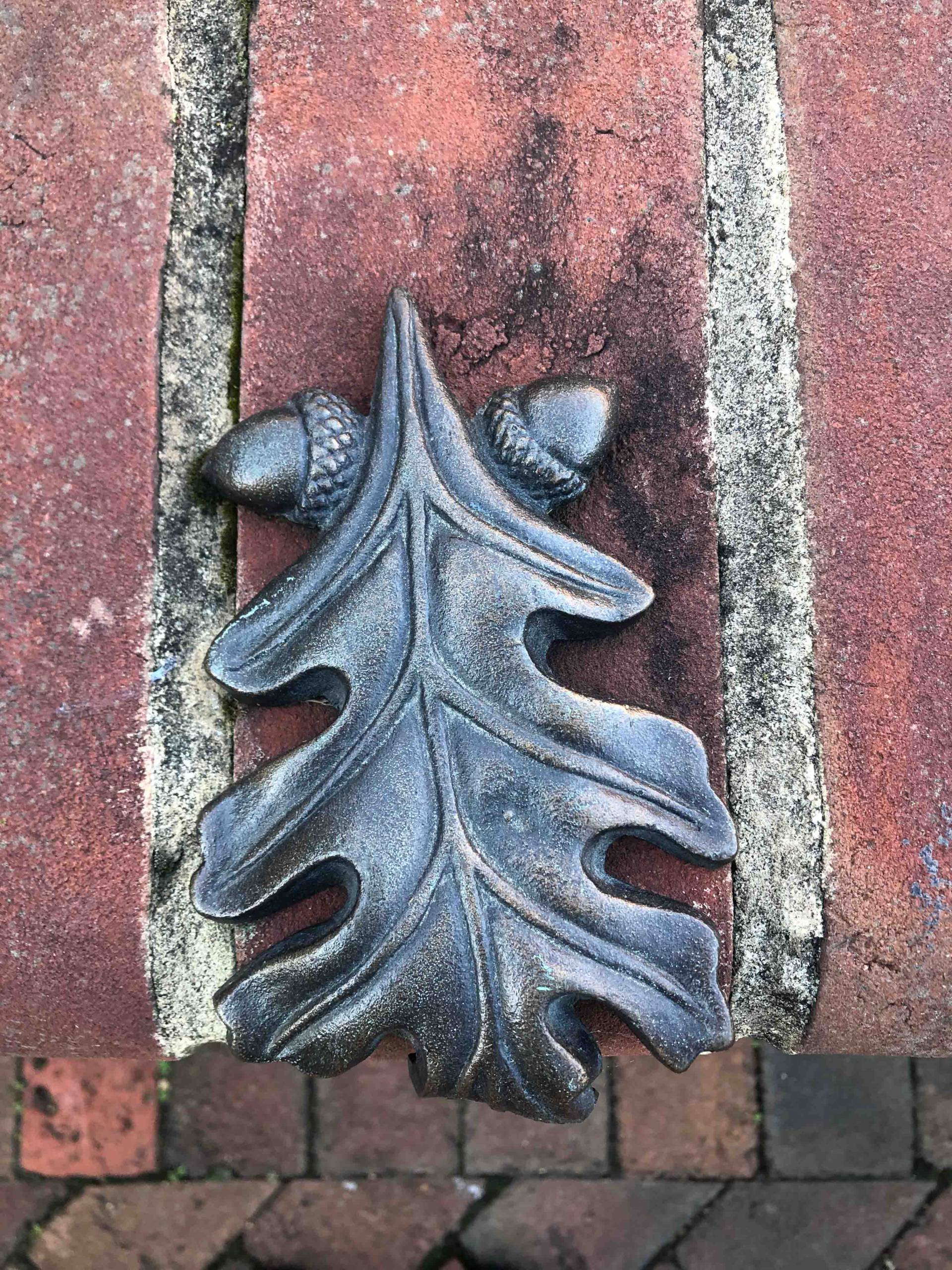 decorative oak leaf with acorns on brick wall